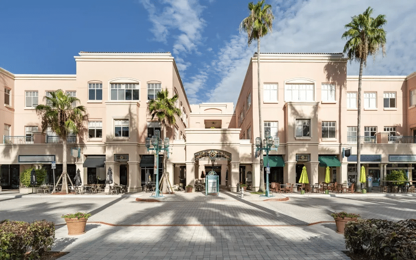 Front view of a building with palm trees